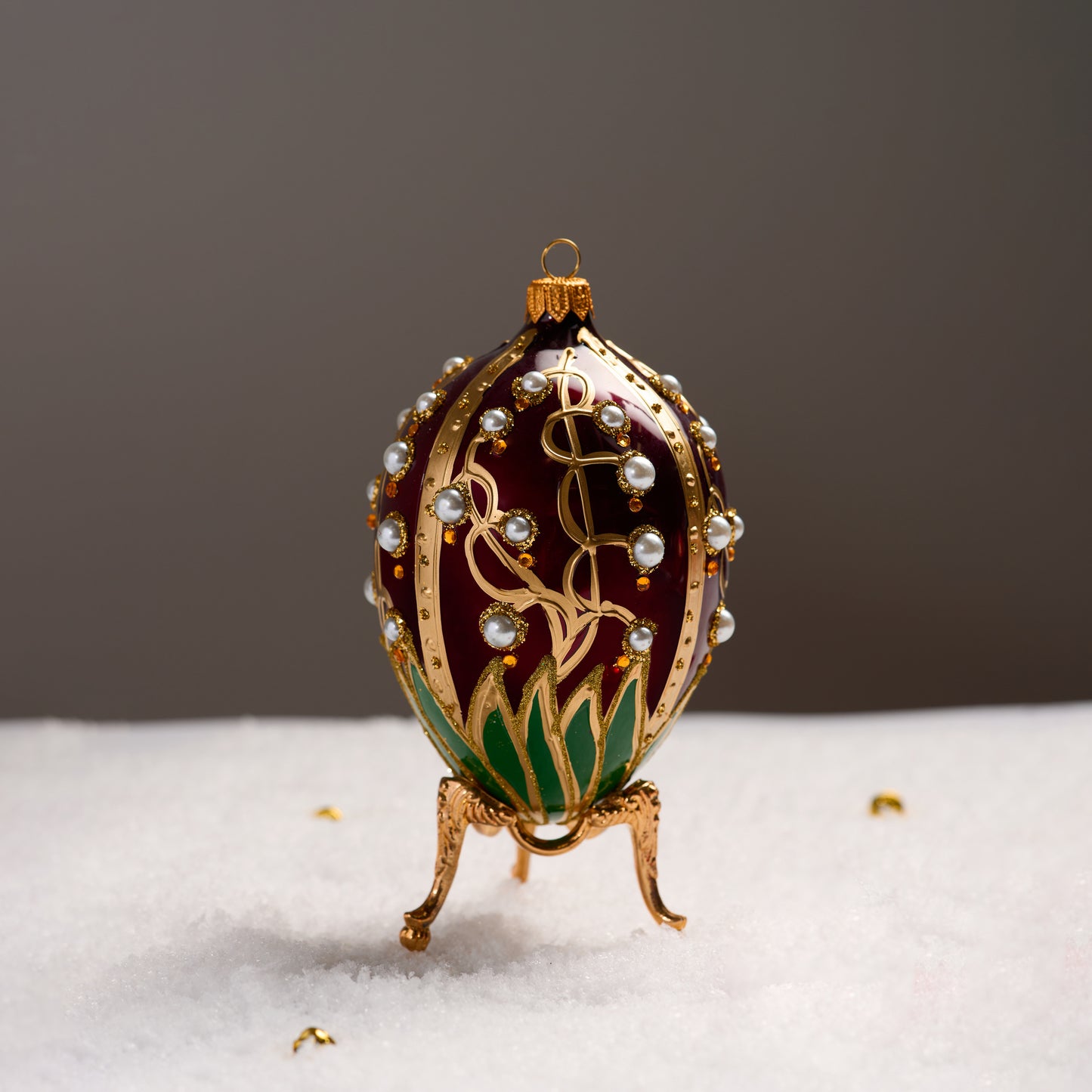 RED FABERGÉ EGG WITH LILY OF THE VALLEY PATTERN